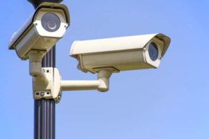 two security cameras on a pole